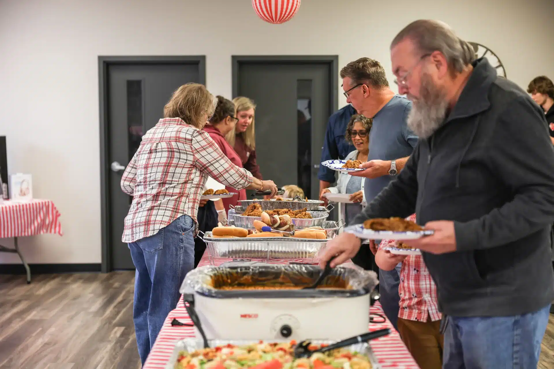 Residents serving themselves along the Festive Celebration buffet in Allendale, MI