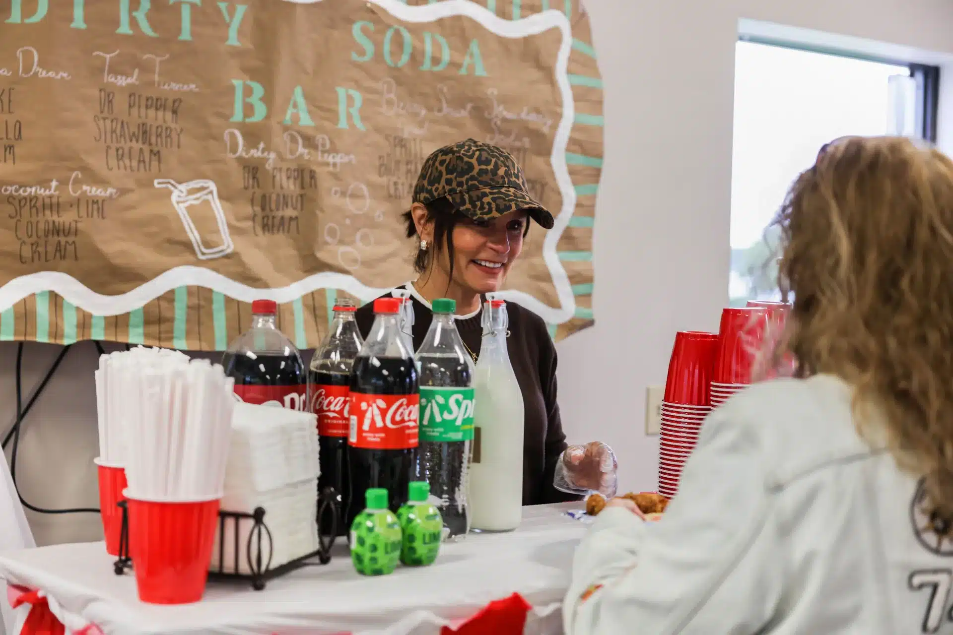 Volunteer smiling behind the dirty soda bar at the Festive Celebration in Allendale, MI