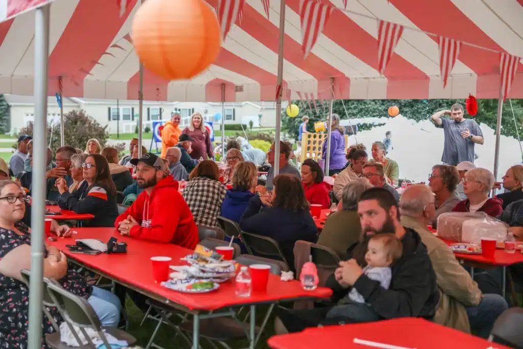 Residents sharing a meal under the Festive Celebration tent