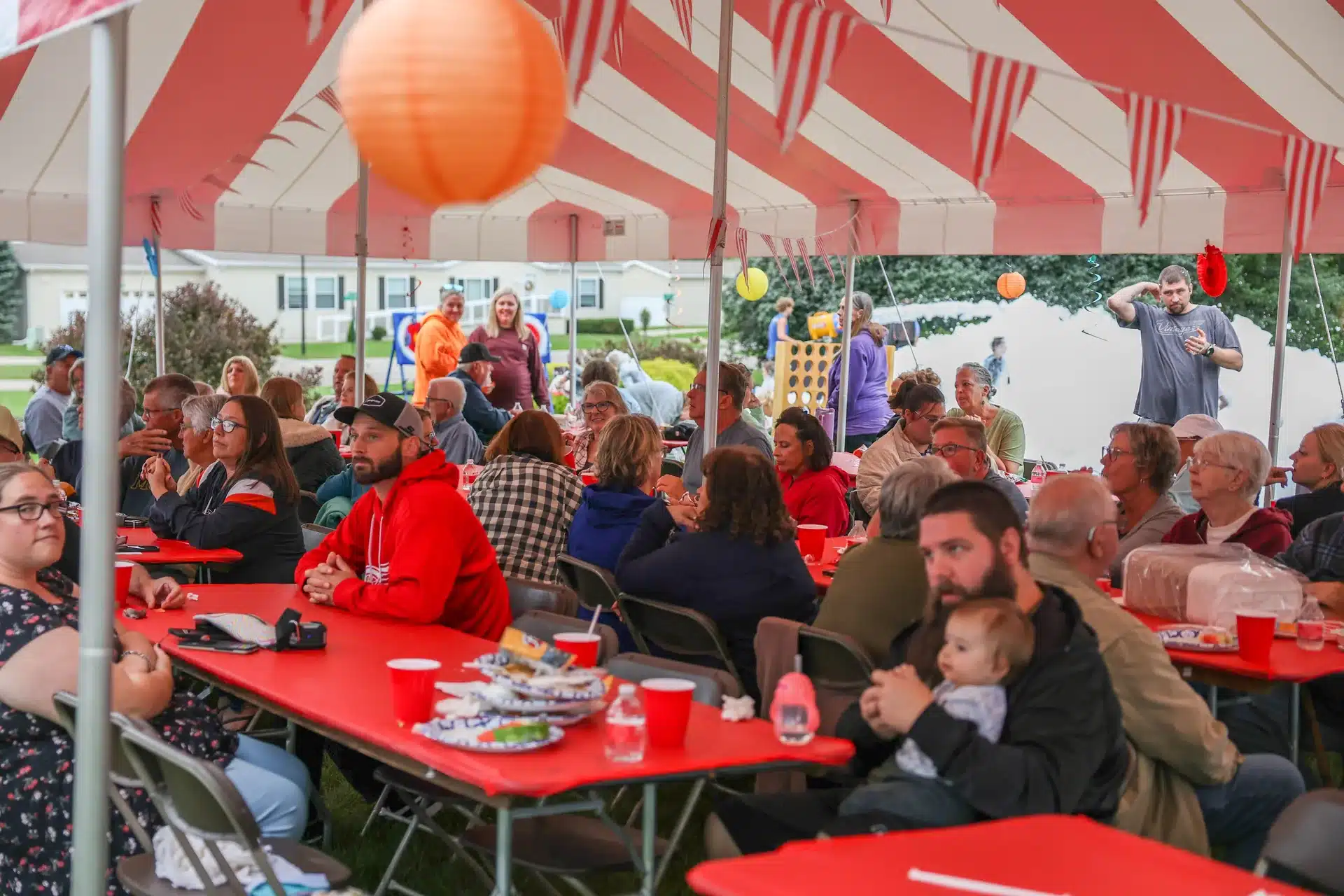 Residents sharing a meal under the Festive Celebration tent in Allendale, MI