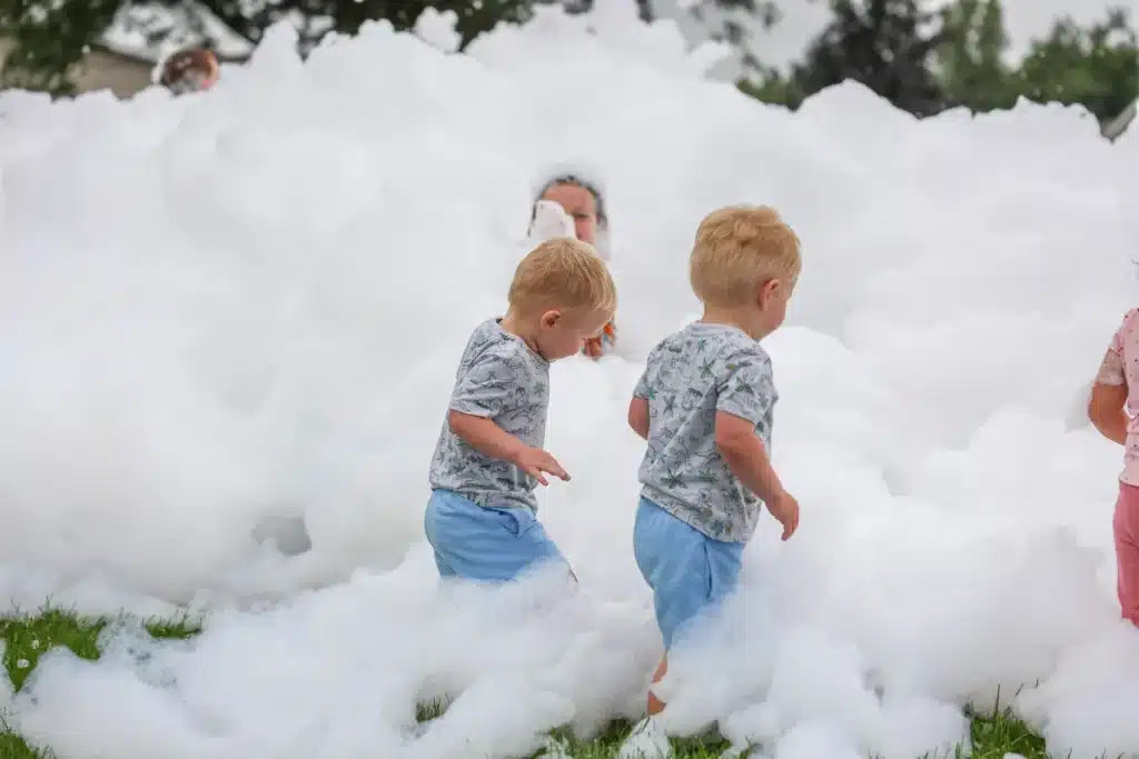 Two young boys playing in foam at the Festive Celebration